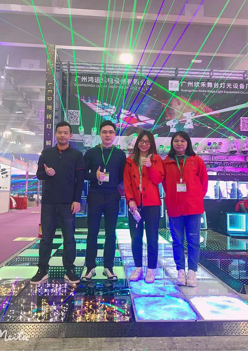 Lucky Dance Floor team showcasing LED dance floor products at a lighting exhibition.