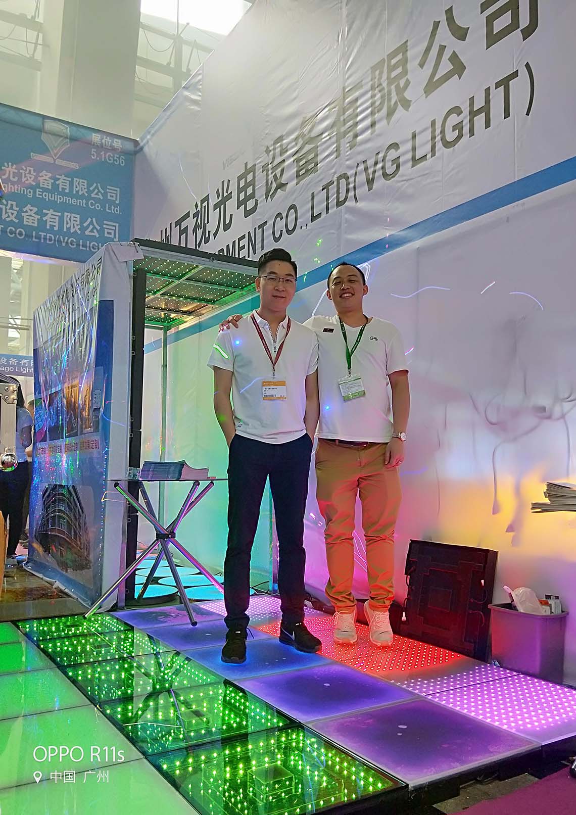 Client demonstration and product presentation on LED dance floor during a lighting show.