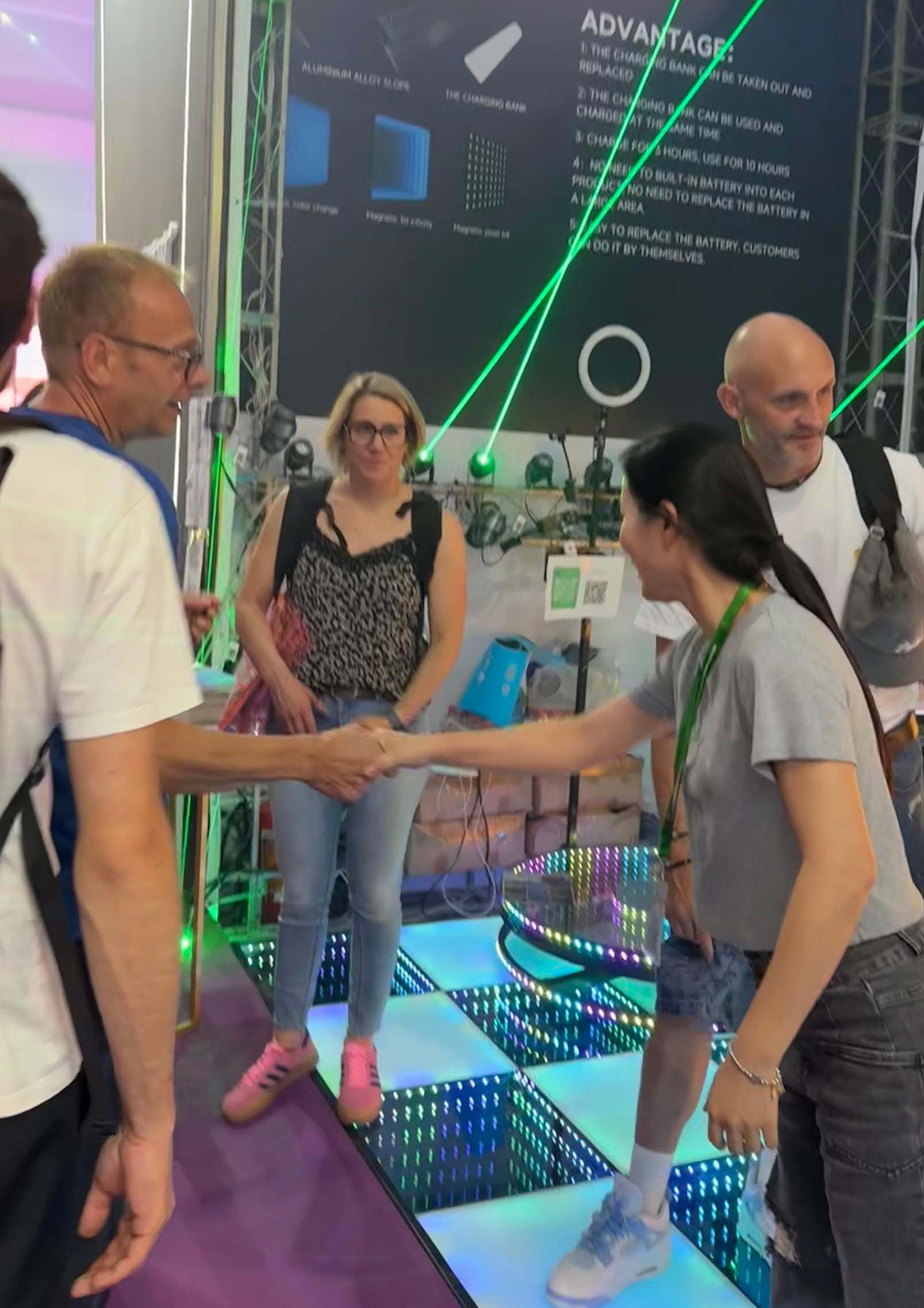 Visitors experiencing a 3D infinity LED dance floor at a professional lighting exhibition.