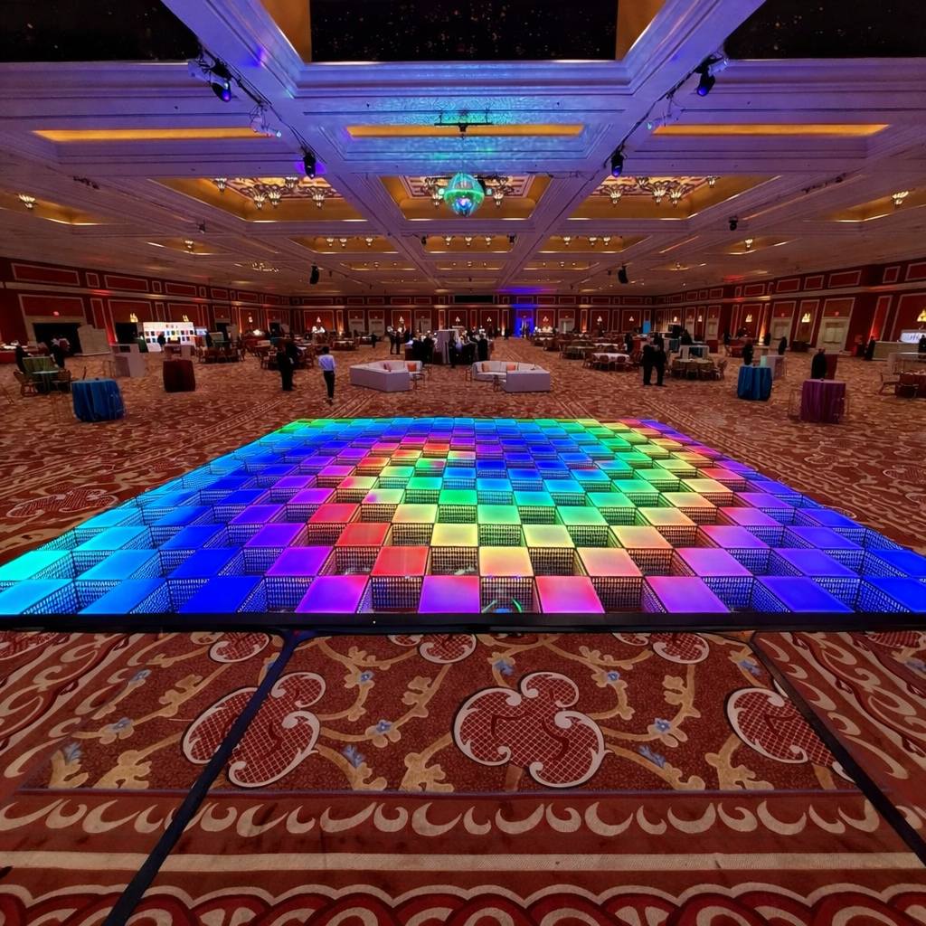 A large checkerboard 3D infinity LED dance floor set up in a grand hotel ballroom for a gala event.