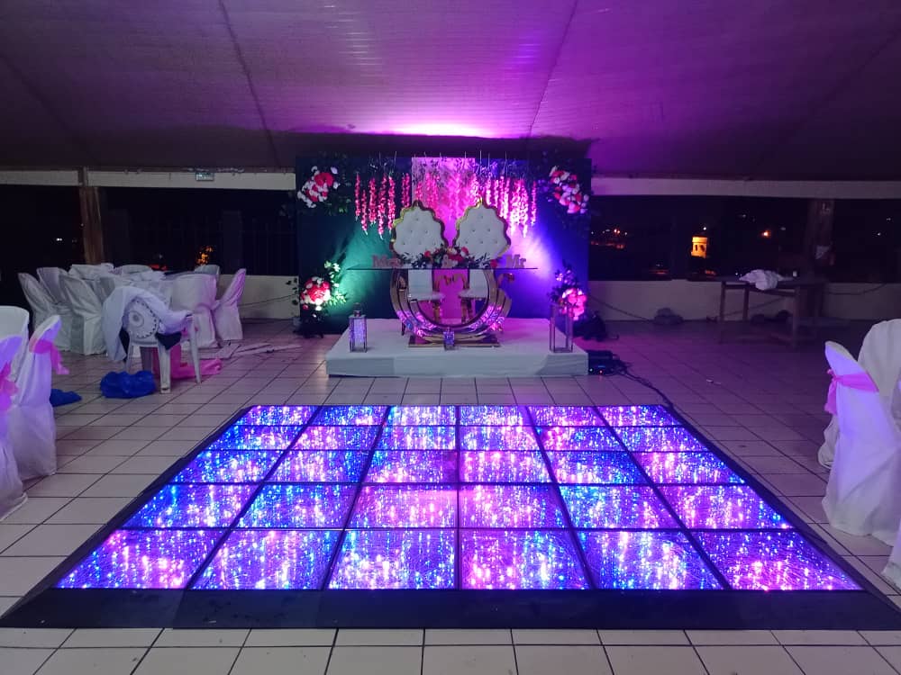 A square full-color starlit dance floor with purple and blue lighting at an indoor banquet hall.