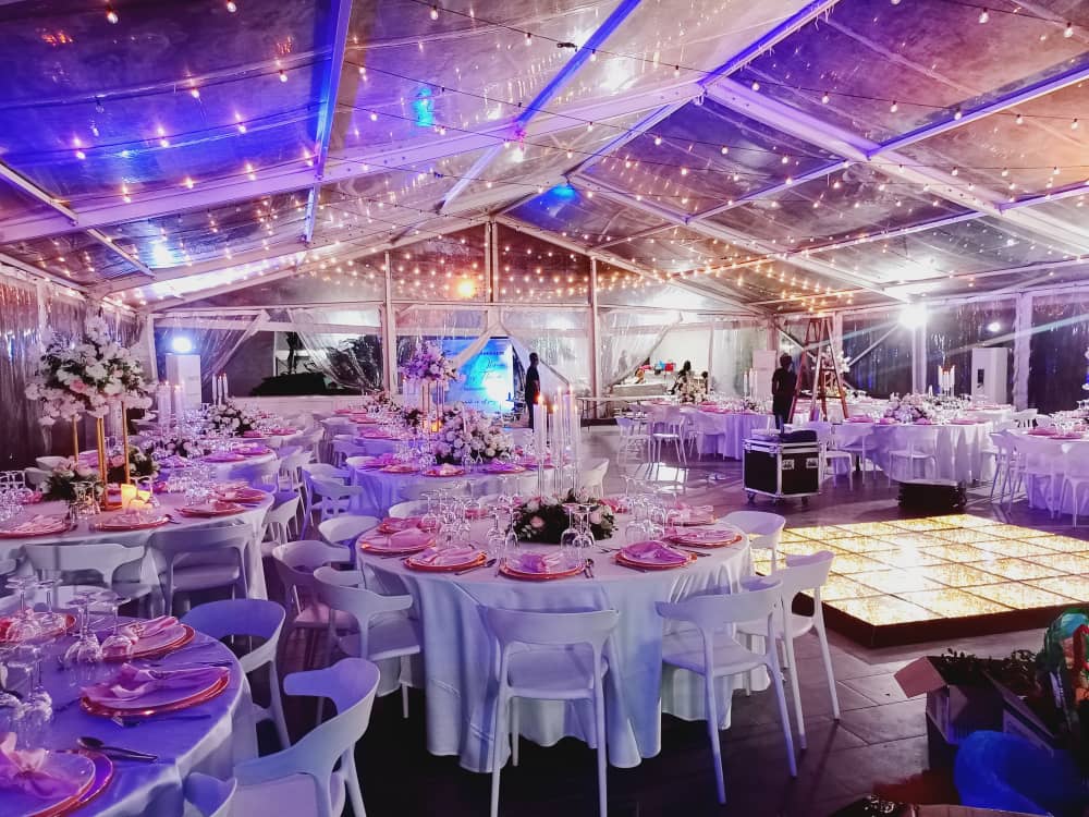 A square full-color starlit dance floor with warm lighting at a luxury outdoor tent wedding reception.