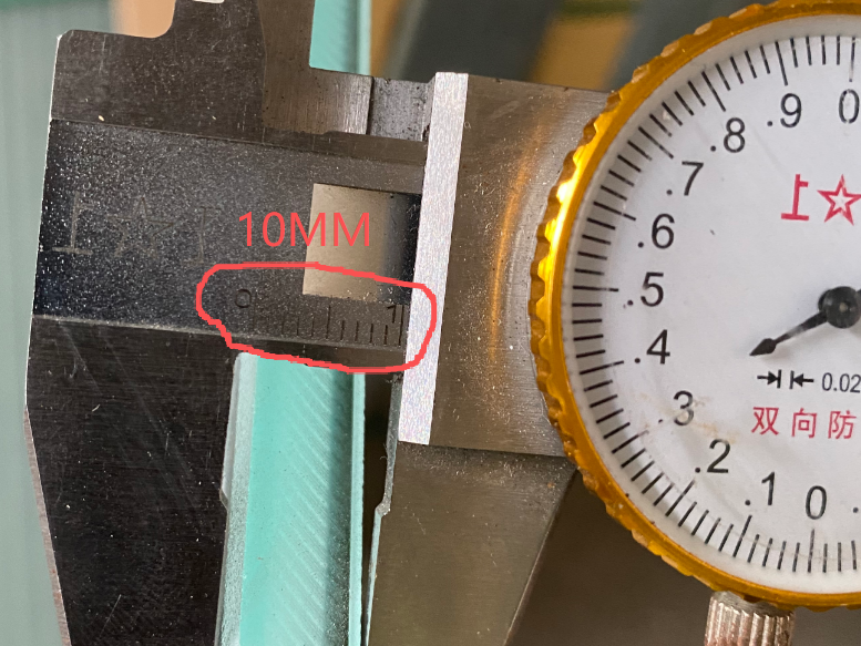 Measuring the 10mm tempered glass thickness of an LED dance floor panel.