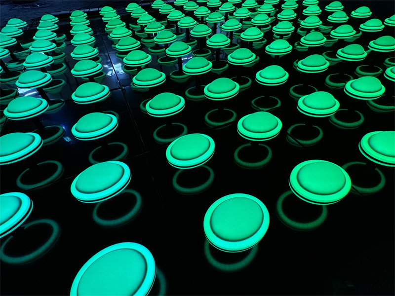 Perspective close-up of 3D dome wall light panels glowing with a bright green LED effect.
