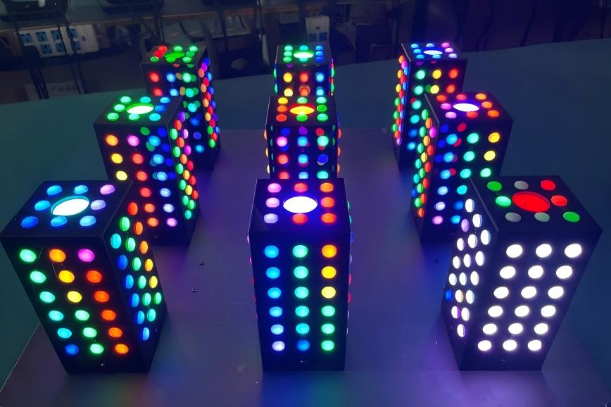 3D pixel pillar lights showing vibrant RGB multicolor lighting effect during factory testing.