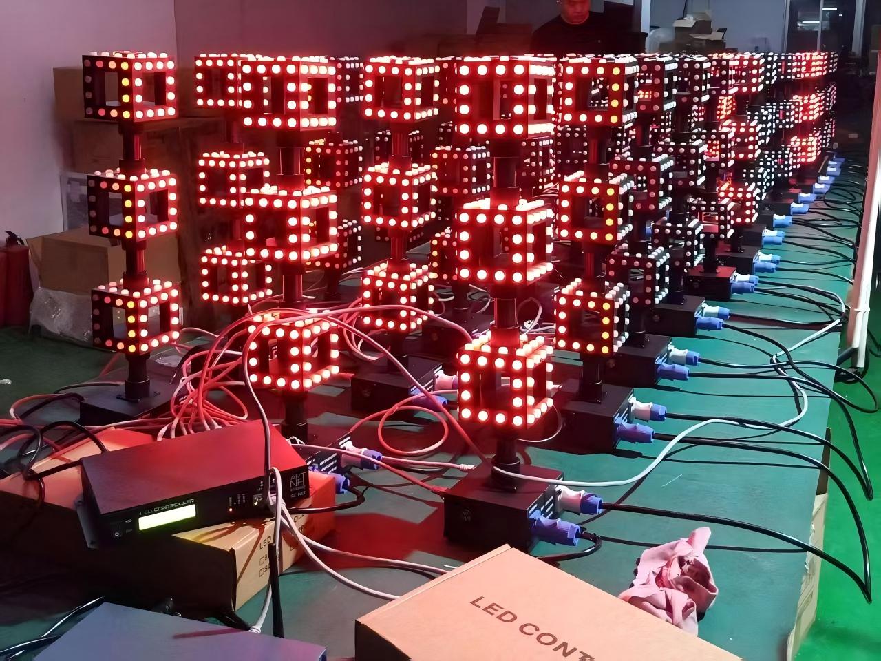 Mass production aging test of modular 3D pixel cube column lights connected to LED controllers in factory.