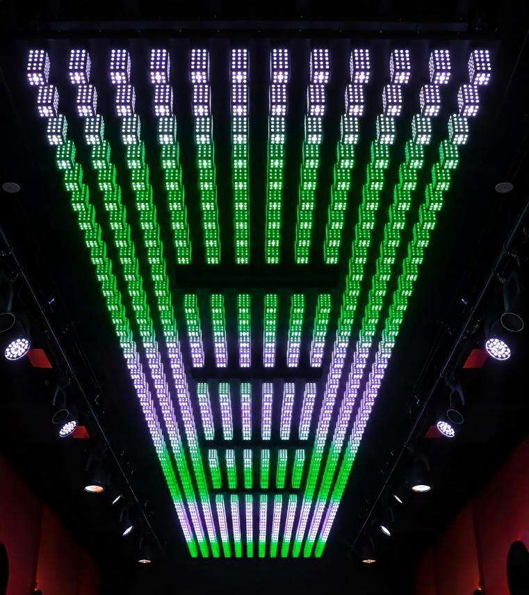 3D pixel pillar lights forming a massive LED matrix ceiling array with green and purple effects in a nightclub.