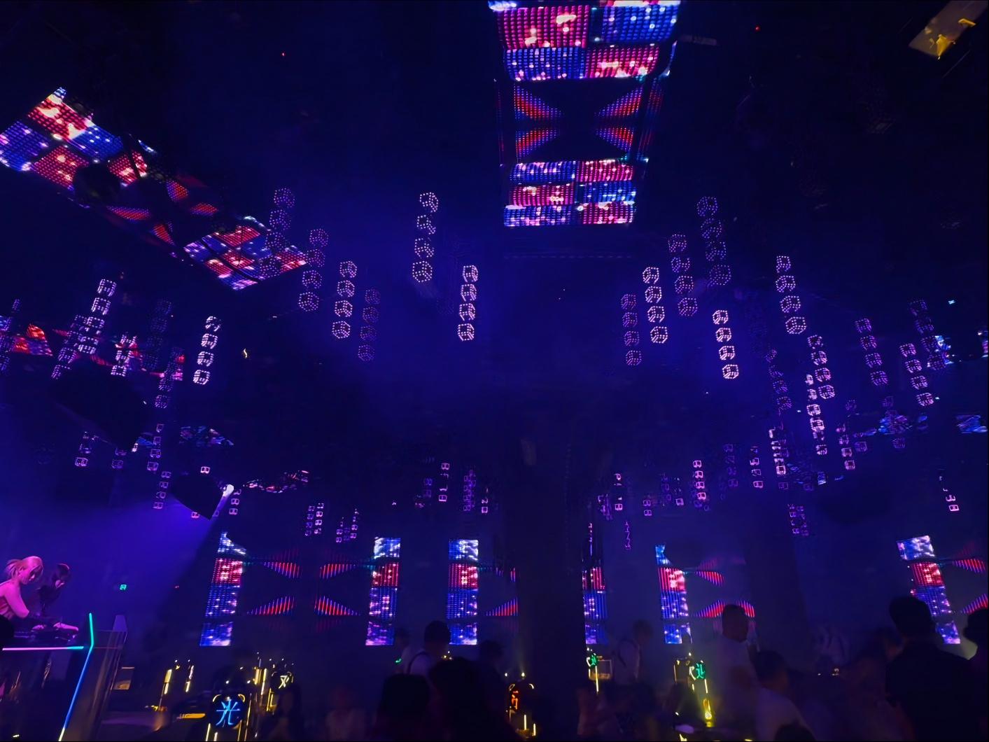 Full venue setup of a modular 3D pixel cube column array installed on a nightclub ceiling with dynamic lighting effects.