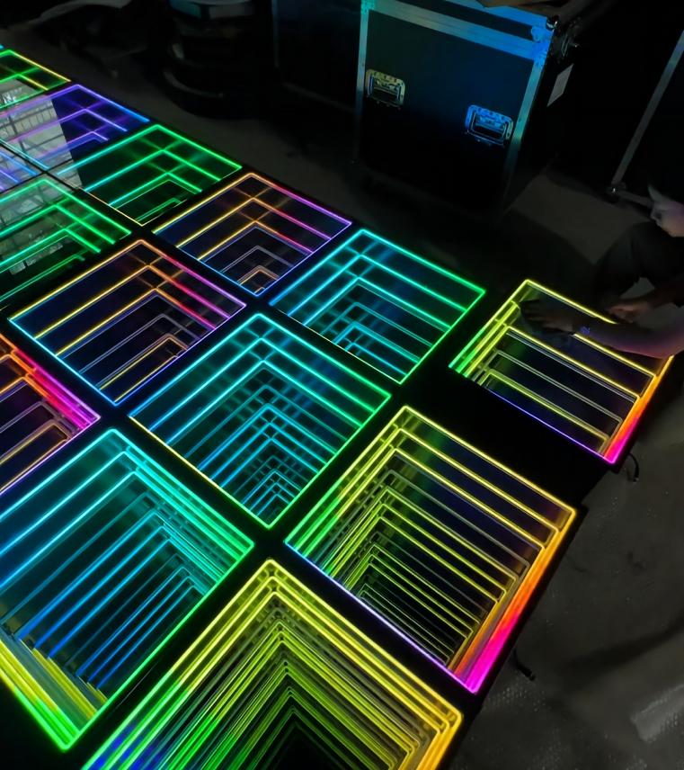 Infinity mirror wall and dance floor panels displaying multicolor LED lighting and deep square tunnel effects.