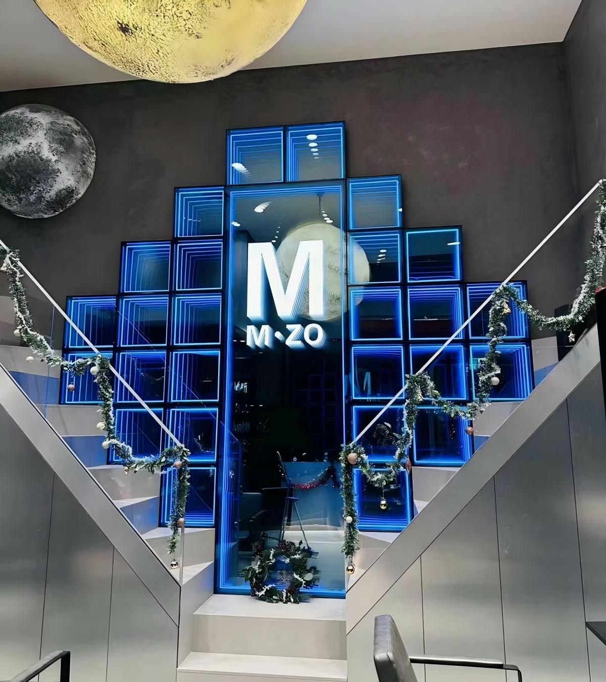Stunning LED infinity mirror wall installation featuring customized infinity mirror wall panels at a modern commercial venue entryway.